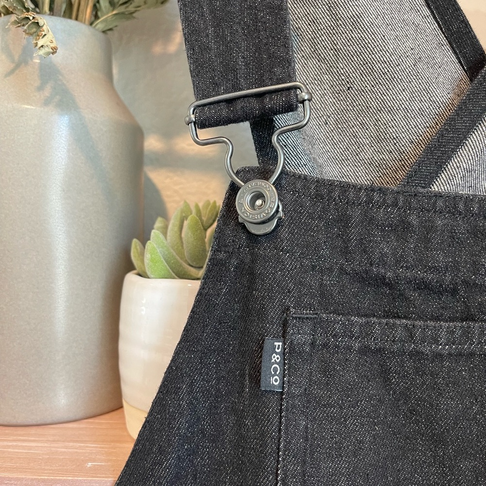 Black denim overalls.